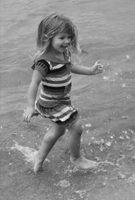 Girl playing in water on the beach